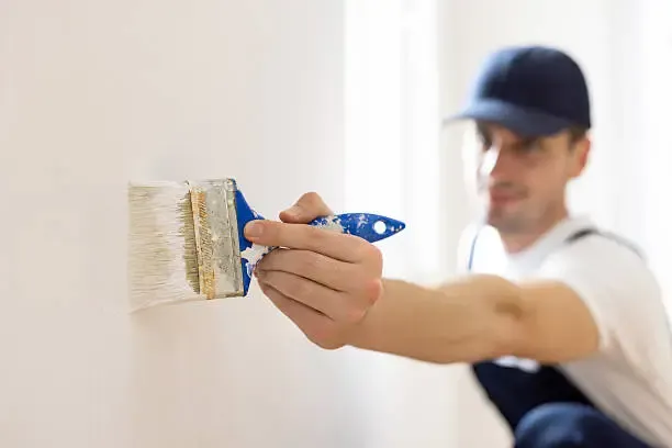 Professional painter working on wall